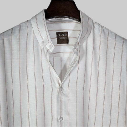 Striped shirt on a hanger with a visible brand label against a light background